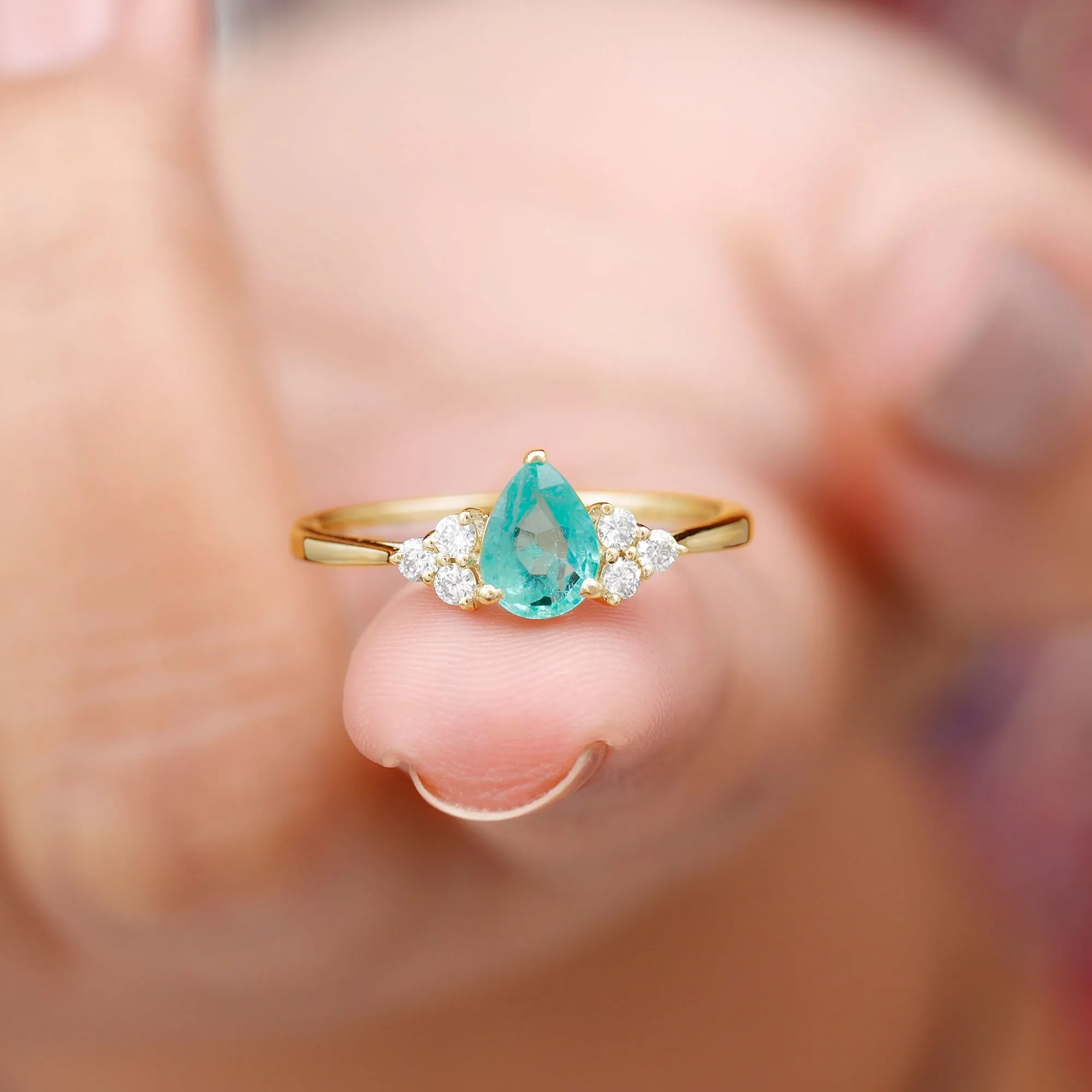 Pear Shaped Emerald Solitaire Ring with Diamond Trio