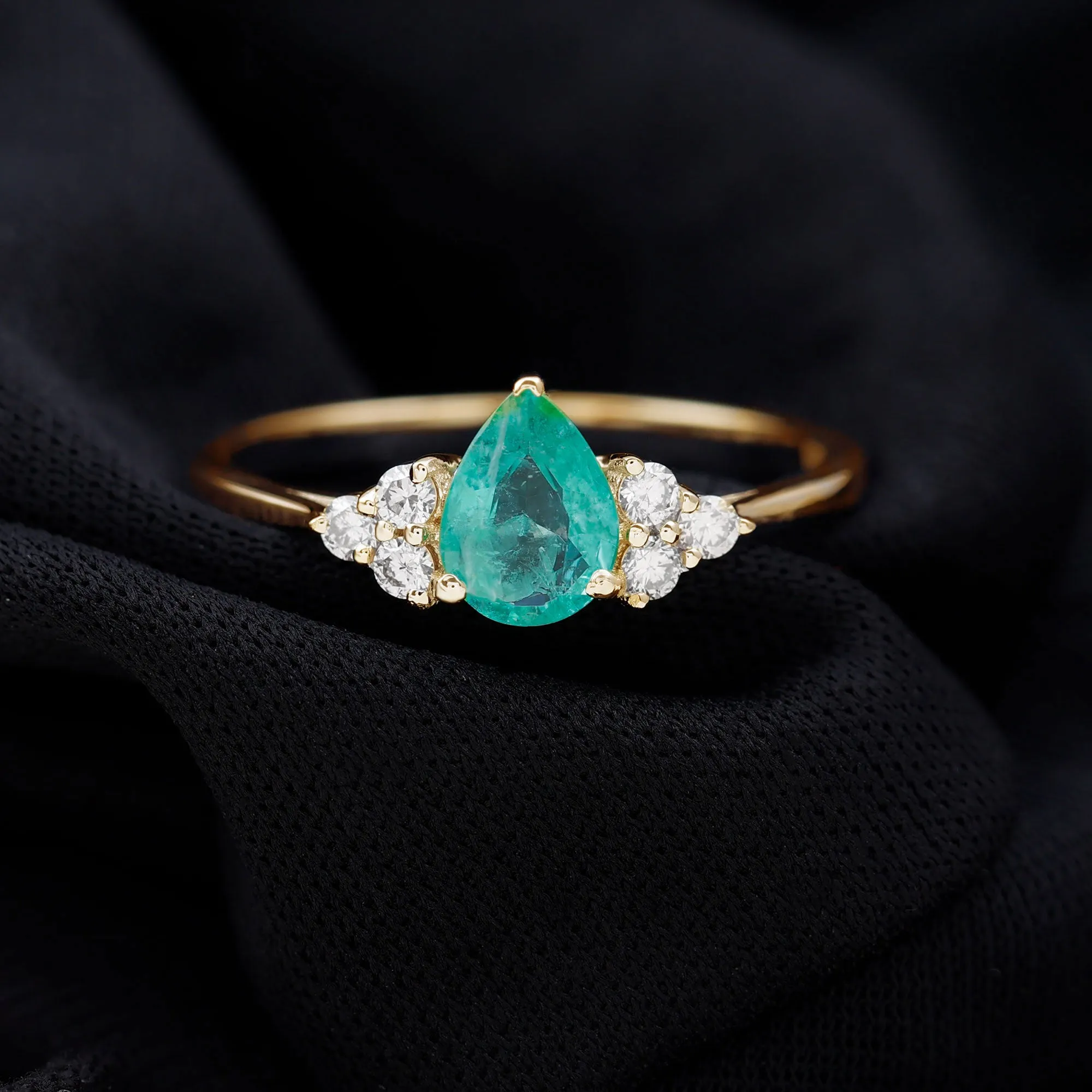 Pear Shaped Emerald Solitaire Ring with Diamond Trio