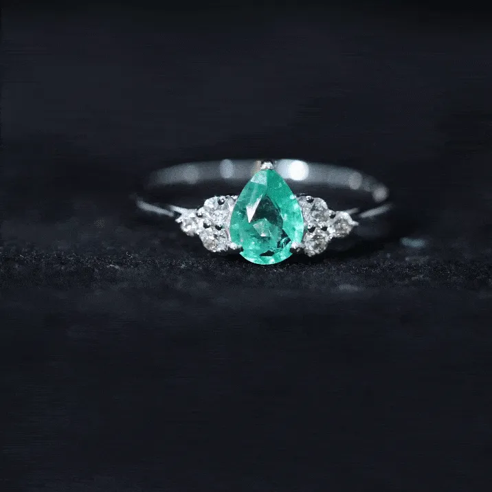 Pear Shaped Emerald Solitaire Ring with Diamond Trio